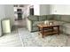 Cozy living area with a gray sectional sofa, wood coffee table, neutral rug and flows into the kitchen at 3784 Scotts Mill Dr, North Charleston, SC 29420