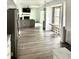 Open-concept living area featuring modern gray plank flooring and a fireplace, flowing seamlessly into a dining space at 3784 Scotts Mill Dr, North Charleston, SC 29420