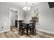 Cozy dining area with a modern light fixture, dining table with seating for four, and natural light at 402 Equinox Cir, Ladson, SC 29456