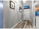Hallway features laminate wood floors and decorative wall art at 402 Equinox Cir, Ladson, SC 29456