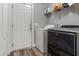 Practical laundry room with a washer, dryer, shelving, and convenient access to the outside at 402 Equinox Cir, Ladson, SC 29456