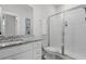 A bright, modern bathroom includes a granite vanity, an ample mirror, and a glass-doored shower at 4114 Maidstone Dr, Mount Pleasant, SC 29466