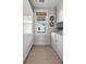 Contemporary laundry room featuring wood-look tile flooring and full storage cabinets at 4114 Maidstone Dr, Mount Pleasant, SC 29466