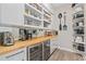 Walk-in pantry with wood countertops, wine fridge, pull out shelving, and appliance storage at 4114 Maidstone Dr, Mount Pleasant, SC 29466