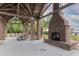 Outdoor pavilion area with a large fireplace, plenty of seating, and a beautiful view of the green scenery at 4114 Maidstone Dr, Mount Pleasant, SC 29466