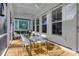 Bright screened porch with a dining table and ample seating, creating an inviting space for entertaining at 4114 Maidstone Dr, Mount Pleasant, SC 29466