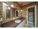 Bathroom featuring an elongated mirror, decorative wallpaper, and a shower in a separate nook at 4328 Cheviot Dr, North Charleston, SC 29418