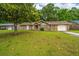 Traditional single story home with brick and vinyl siding, a front yard, and an attached garage at 4328 Cheviot Dr, North Charleston, SC 29418