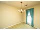 Cozy living room features bright window with teal curtains and a vintage chandelier at 4328 Cheviot Dr, North Charleston, SC 29418