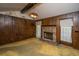 Living room with a brick fireplace, wood paneling, carpeted floor and a vintage light fixture at 4328 Cheviot Dr, North Charleston, SC 29418