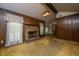 A living room showcasing a brick fireplace, wood paneling and a vintage light fixture at 4328 Cheviot Dr, North Charleston, SC 29418