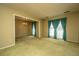 Spacious living room with carpeted floor, large windows and an open doorway into a dining room at 4328 Cheviot Dr, North Charleston, SC 29418