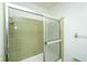 Walk-in shower with sliding doors and green tiling at 4328 Cheviot Dr, North Charleston, SC 29418