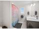 Bright bathroom featuring a single sink vanity, mermaid shower curtain and tile flooring at 4404 Avery Ave, North Charleston, SC 29405