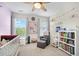 Charming Bedroom featuring a crib, bookshelf filled with books, and cozy armchair at 4404 Avery Ave, North Charleston, SC 29405