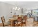 Modern dining area featuring stylish lighting and a wood table with seating at 4404 Avery Ave, North Charleston, SC 29405