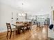 Open concept dining room and kitchen with hardwood floors and stainless steel appliances at 4404 Avery Ave, North Charleston, SC 29405