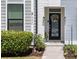 Charming front entrance with a floral wreath, well-manicured bushes and nice landscaping at 4404 Avery Ave, North Charleston, SC 29405