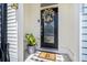 A close-up of a welcoming front door with a floral wreath and stylish welcome mat at 4404 Avery Ave, North Charleston, SC 29405