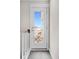 Hallway view to door leading to a private balcony with furniture for outdoor relaxation at 4404 Avery Ave, North Charleston, SC 29405