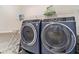 Convenient laundry room featuring front-load washer and dryer set with folding rack at 4404 Avery Ave, North Charleston, SC 29405