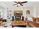 Bright living room with hardwood floors, large sectional, and decorative fireplace at 4404 Avery Ave, North Charleston, SC 29405