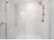 Modern shower with glass enclosure and marble-patterned walls and bench seat at 4404 Avery Ave, North Charleston, SC 29405