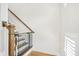 Bright staircase featuring stained wood handrail and a baby gate for safety at 4404 Avery Ave, North Charleston, SC 29405