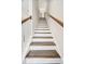Carpeted stairway with white risers and stained wood handrail at 4404 Avery Ave, North Charleston, SC 29405