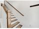 Bright stairway features carpeted treads, white risers and balusters, and wood handrail at 4404 Avery Ave, North Charleston, SC 29405