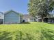 Spacious backyard with grass, a detached garage, and a privacy fence at 4818 Holly Berry Ln, Summerville, SC 29485