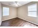 A cozy bedroom with warm neutral walls, wood floors, ceiling fan and natural light from the window at 4818 Holly Berry Ln, Summerville, SC 29485