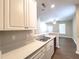A bright kitchen view with stone-look counters, stainless steel sink, and open floorplan concept at 4818 Holly Berry Ln, Summerville, SC 29485