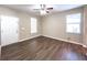 A well-lit living room is brightened by two windows and features wood-look flooring and a ceiling fan at 4818 Holly Berry Ln, Summerville, SC 29485
