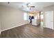 A view of the living room with wood-look floors transitions into the kitchen with an archway entrance at 4818 Holly Berry Ln, Summerville, SC 29485