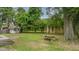 Lush backyard with mature trees, a picnic table, and a small shed provides a serene outdoor space at 4924 France Ave, North Charleston, SC 29405