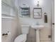Bright bathroom featuring a pedestal sink, modern fixtures, and built-in shelving at 4924 France Ave, North Charleston, SC 29405