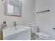 Clean bathroom with white vanity, decorative mirror, and modern toilet features a sleek design at 4924 France Ave, North Charleston, SC 29405