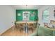 Dining area with stylish decor, hardwood floors, and a vibrant accent wall, perfect for gatherings at 4924 France Ave, North Charleston, SC 29405