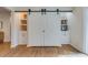 Stylish living area featuring barn doors, built-in shelves, and rich hardwood floors at 4924 France Ave, North Charleston, SC 29405