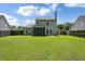 Well-maintained backyard featuring lush green lawn and privacy fence at 4977 Ballantine Dr, Summerville, SC 29485