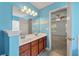 This bathroom offers a dual sink vanity, a large mirror, and tile flooring at 4977 Ballantine Dr, Summerville, SC 29485
