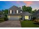 Charming two-story home featuring a well-manicured lawn, two car garage and beautiful, mature landscaping at 4977 Ballantine Dr, Summerville, SC 29485