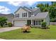 Charming two-story home featuring a well-manicured lawn, two car garage and beautiful, mature landscaping at 4977 Ballantine Dr, Summerville, SC 29485