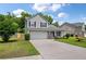 Charming two-story home featuring a well-manicured lawn, two car garage and beautiful, mature landscaping at 4977 Ballantine Dr, Summerville, SC 29485