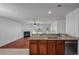 Open concept kitchen with granite countertops, stainless steel appliances, and view of the living room with fireplace at 4977 Ballantine Dr, Summerville, SC 29485