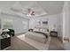 This spacious main bedroom offers a trey ceiling with a fan, carpet, and neutral walls at 4977 Ballantine Dr, Summerville, SC 29485