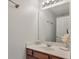 This powder room features a single sink vanity with a decorative mirror and tile flooring at 4977 Ballantine Dr, Summerville, SC 29485