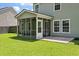 Rear exterior featuring a screened porch and a well manicured lawn at 4977 Ballantine Dr, Summerville, SC 29485