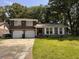 Charming two-story brick home with a well-manicured lawn and a two-car garage nestled among mature trees at 5 Apple Cir, Goose Creek, SC 29445